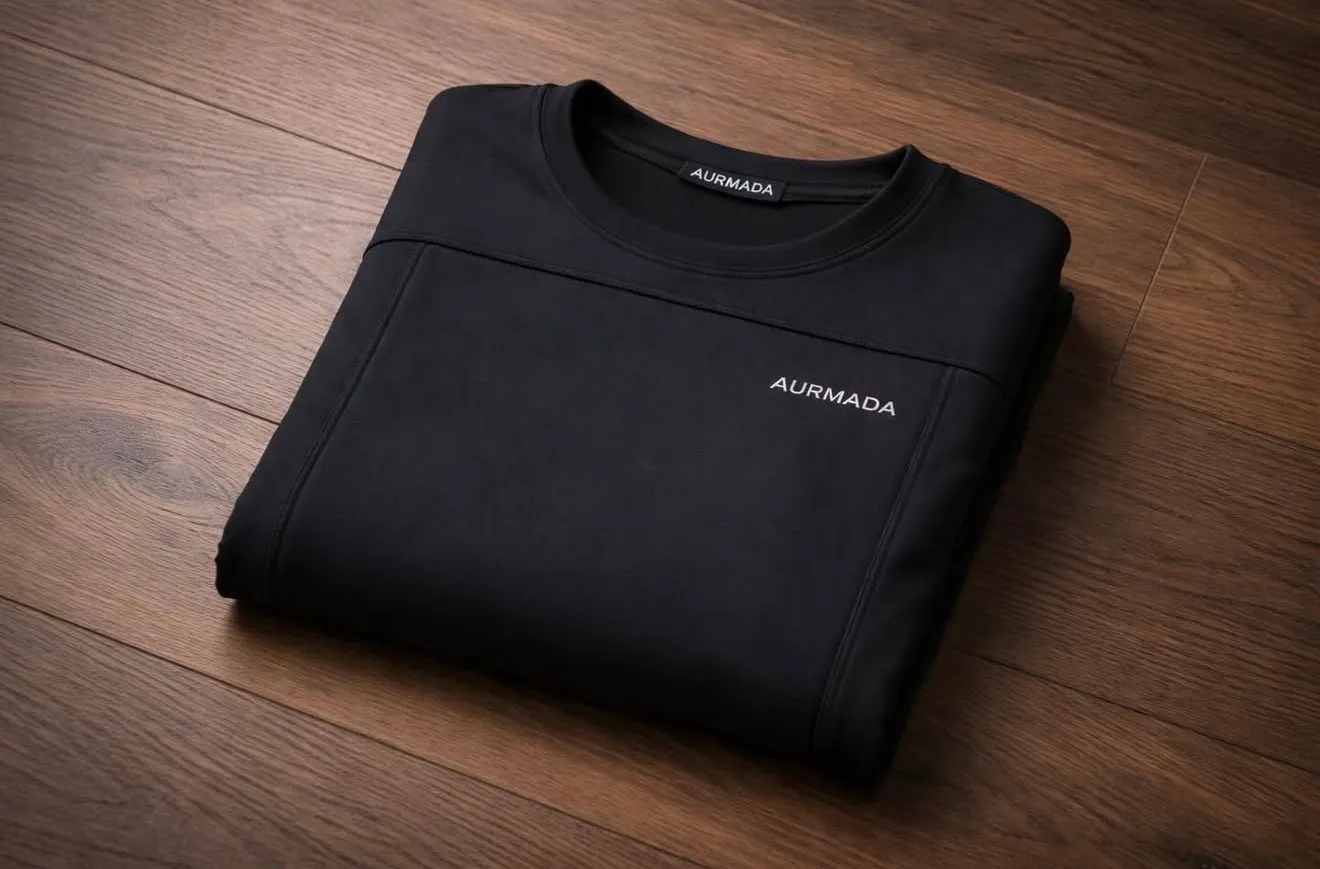 Model wearing a black Aurmada Layer 1 bullet-resistant performance shirt in a dark studio
